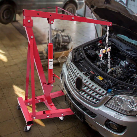 Heavy Duty Folding Hydraulic Engine Hoist And Crane, 2 Ton Capacity With Portable Wheels, red hoist beside open car hood.