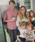 Family in kitchen holding mason jars with 10 Pack Wide Mouth Platinum Silicone Sealing Rings Gaskets For Mason Jar Lids Leak Proof And Air Tight Reusable Seals Durable Fits 3 Inch Wide Mouth Jars For Fresh Food Storage And Easy Preserving.