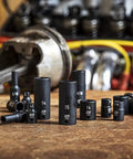 28 Piece One Quarter Inch Drive Six Point Impact Socket Set Metric Standard And Deep Sockets Off Corner Loading Manganese Phosphate Finish Built For Pros displayed on workbench.