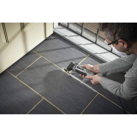 User cutting gray flooring with Reconditioned Corded Oscillating Multi Tool Kit Featuring Durable Metal Frame Engineered For Sharp Cutting Sanding Scraping And Grinding Plug And Play Workhorse Built Like A Dang Tank To Finish Jobs Fast