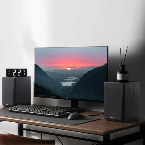R990BT 2.0 Active Bluetooth Multimedia Speakers with bookshelf style next to PC monitor on wooden desk