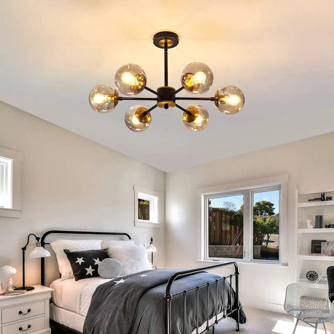 Lit Six Light Black Glass Globe Chandelier For Living Room And Kitchen Island in modern farmhouse bedroom setting