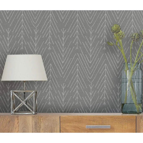 Charcoal Gray Twig Hygge Herringbone Peel And Stick Wallpaper 20.5 Inches Wide 16.5 Feet Long on wall with lamp and decor