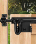 Beast Mode Heavy Duty Slide Bolt Gate Latch Black Powder Coated Steel Barn Door Hardware With Padlock Hole mounted on wooden fence.