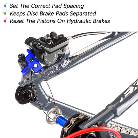 Six Piece Hydraulic Disc Brake Pad Spacer Set with Pro Grade Bleed Blocks installed on bike brake caliper in blue plastic