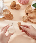 Hands holding Two Size Wood Cork Plugs 10 Pack Large Tapered Wooden Stoppers For Wine Beer And Glass Bottles Ornaments DIY