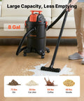 Person using 8 Gallon Wet Dry Shop Vacuum With 4.5 Peak HP Portable Grab And Go Power One Button Self Cleaning Dual Filter System 900W Input Power 1.25 Inch By 7 Foot Hose 9.8 Foot Cord Built For Jobsite Garage Workshop Or Home Cleanup on a wet floor with debris.