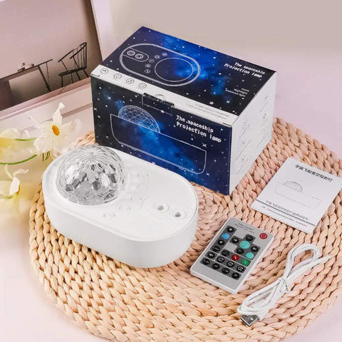 3 In 1 Starry Night Projector With Ocean Wave Nebula Effects Bluetooth Music Speaker next to remote and packaging