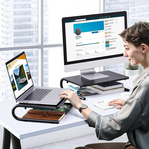 Person using Desktop Monitor Stand With Dope Ventilated Perforated Steel Design as laptop shelf and desk organizer in office setting.