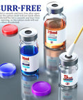 Sterile glass vials with silver flip-top caps and self-healing ports; three vials with blue, orange, and clear liquids.