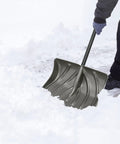 Person using All In One 20 Inch Snow Shovel And Pusher Combo With Galvanized Steel Wear Strip And Ergonomic D Grip Handle For Easy Snow Removal On Driveways Walkways And Sidewalks Gray on snow-covered ground