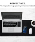 Gamer-Grade Extended Mouse Pad with Stitched Edges and Non-Slip Natural Rubber Base, 27.6 by 11.8 inches on desk with laptop