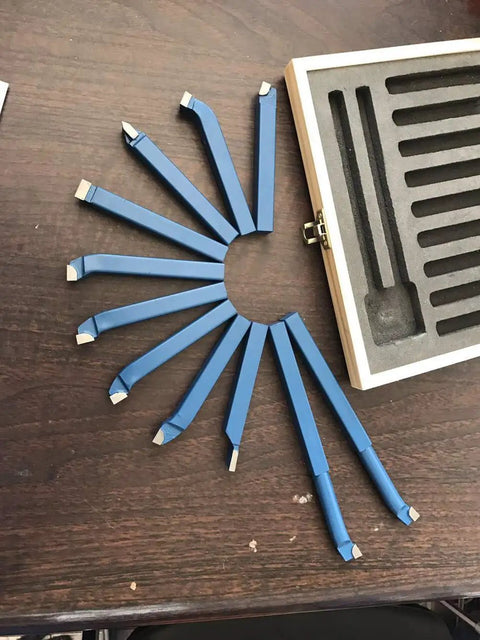 Top Shelf 11 Piece Tungsten Carbide Lathe Turning Tool Set With Heavy Duty Boring Bars and Roughing Grooving Inserts built tough, displayed in a fan shape.