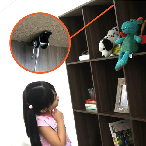 Child looking at bookshelf secured with Anti Tip Furniture Anchors For Dresser, Bookshelf And Cabinet Safety, Heavy Duty Wall Straps Kit