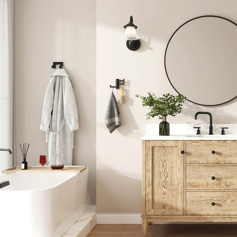 Super Slick Swivel Towel Hook With Three Turning Arms Matte Black Wall Mount Coat Rack holding a robe and towel in a stylish bathroom.