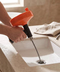 Heavy Duty Manual Drain Snake Auger For Home Plumbing Quick Clog Remover with ergonomic grip, cleaning sink drain.