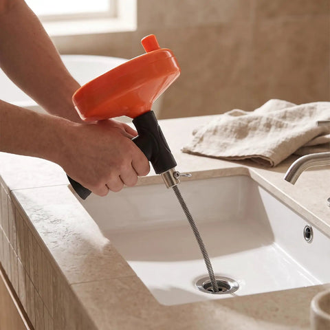 Heavy Duty Manual Drain Snake Auger For Home Plumbing Quick Clog Remover with ergonomic grip, cleaning sink drain.