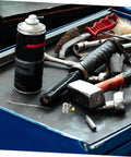 90 Degree Stainless Steel Grease Nozzle Kit With Angled Fittings on a workshop table with tools and grease can
