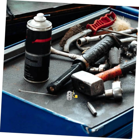 90 Degree Stainless Steel Grease Nozzle Kit With Angled Fittings on a workshop table with tools and grease can