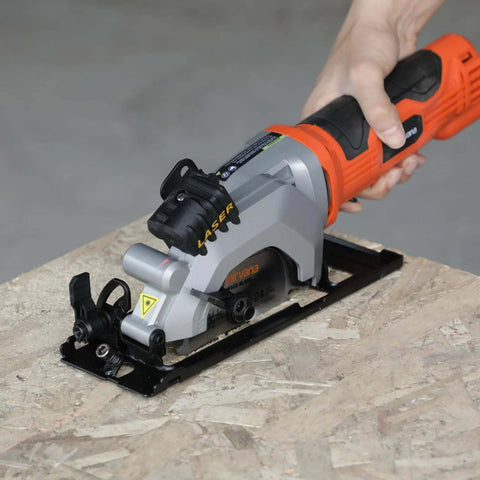 Front view of Yunirvana 4Amp mini circular saw with laser guide; orange body, gray housing, on wood work surface