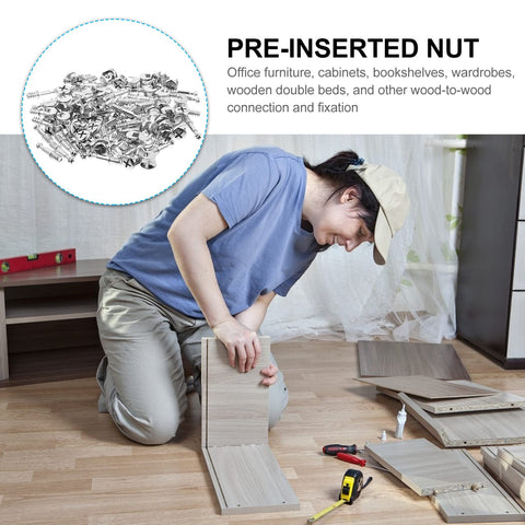 Person assembling wood panels using Two In One 50 Pack 28mm Alloy Furniture Connectors Kit With Cam Lock Fittings And Pre Inserted Nuts