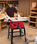 10 Inch 15 Amp Tough Job Site Table Saw With Rock Solid Stand And Push Stick used for precise cuts on wood in workshop.
