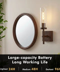 Kwinmyso Wireless 3CCT Wall Sconce Battery Operated Dimmable Wall Light beside a round mirror and green plants.