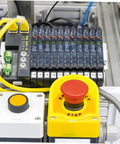 Yellow plastic guard covering emergency stop switch, featuring 2 Pack Stop Button Protective Covers For Emergency Stop Switches Industrial Plastic Guard To Prevent Accidental Activation Safety Shield For Machines Today.