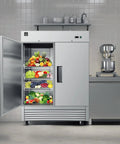 Heavy Duty Commercial Reach In Upright Refrigerator With Slick Stainless Finish Boasting A Massive Forty Three Cubic Foot Layout filled with fresh fruits and vegetables.