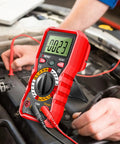 Digital Multimeter With Protective Case For Home And Auto Electrical Testing in use on a car engine