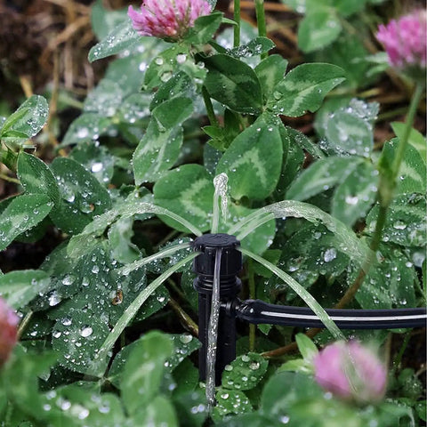 Close-up of 60 Piece 360 Degree Drip Irrigation Emitters for 1 Quarter Inch Tubing in action watering plants