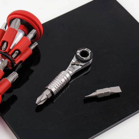 Ultra Compact One Quarter Inch Ratchet Wrench For Tight Spaces Stainless steel EDC Tool with bits on a black surface