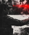 Person using 1000 Lumen Rechargeable LED Flashlight with red front light while fishing, demonstrating night vision capability.
