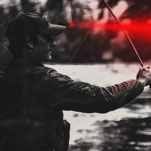 Person using 1000 Lumen Rechargeable LED Flashlight with red front light while fishing, demonstrating night vision capability.