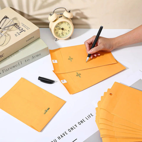 Person writing on 200 Pack 5 By 7 Inch Clasp Manila Envelopes With Gummed Closure 28 Lb Paper Yellow Office Mailer Envelopes for Home and Biz Use