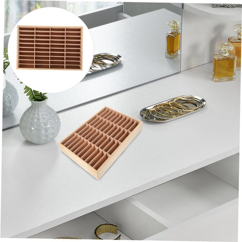 Slick Multi Grid Jewelry Tray Wooden Desktop Organizer Phone Stand For Rings Earrings And Bracelets on a vanity, holding jewelry.