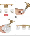 Assembly of Gold Three Light Vanity Fixture With Clear Glass Globe Shades For Bathroom Modern Soft Gold Finish 22 Inch Long