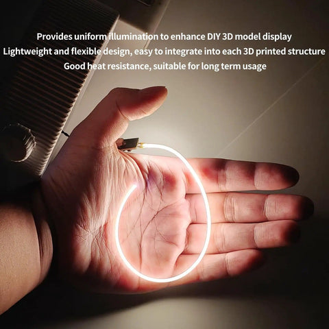 Hand holding a glowing 200mm COB Silicone LED Strip Light With PCB Interface Board Build Kit For P1P P1S X1 X1C A1 And A1 Mini Makeworld DIY Custom Lamp Projects