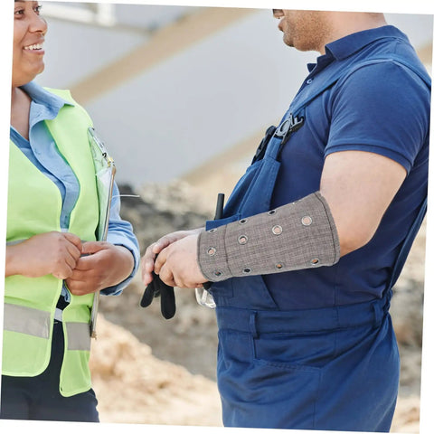 Man wearing Heavy Duty Cut Resistant Wrist Sleeves For Men And Women Beefy Arm Guards during a work discussion.