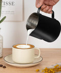 20Oz Stainless Steel Milk Frothing Pitcher With Clear Measurement Scale For Cappuccino And Latte Art, Pro Grade Barista Tool, pouring milk into a cappuccino