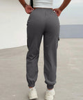 Back view of Women Lightweight Quick Dry Cargo Hiking Pants With High Waist Fit All Day Comfort Stretchy Parachute Style Baggy Travel Joggers.