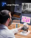 Man using 7-Inch Screen Digital Microscope with X-Y Stage, HDMI and USB output showing colorful slide, wireless app control visible.