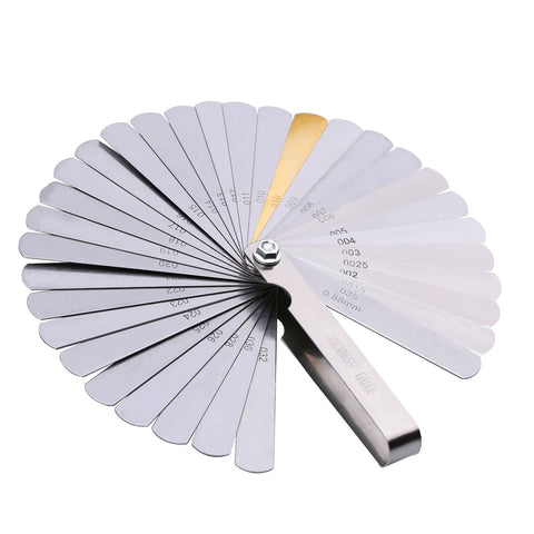 32-blade stainless steel feeler gauge with dual metric and imperial markings, fanned open for gap measurement.
