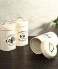 Heavy Duty Metal Coffee Canister Set Of Three Wide Mouth Kitchen Storage Jars For Beans Tea Sugar And Nuts Keeps Your Daily Grind Locked In And Looking Crisp On Counters. Two canisters labeled coffee and tea.