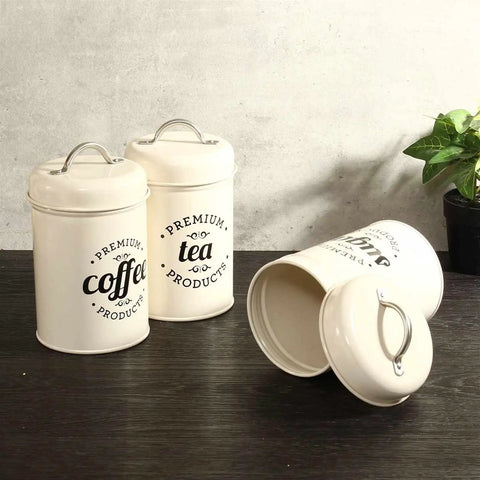 Heavy Duty Metal Coffee Canister Set Of Three Wide Mouth Kitchen Storage Jars For Beans Tea Sugar And Nuts Keeps Your Daily Grind Locked In And Looking Crisp On Counters. Two canisters labeled coffee and tea.