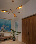 51 Inch Industrial Farmhouse Chandelier With Antique Brass Brush Finish And Matte Black Wood Pendant Lighting in a modern room