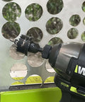 WORX cordless drill with metal bi-metal hole saw attachment cutting circular holes in perforated metal panel.