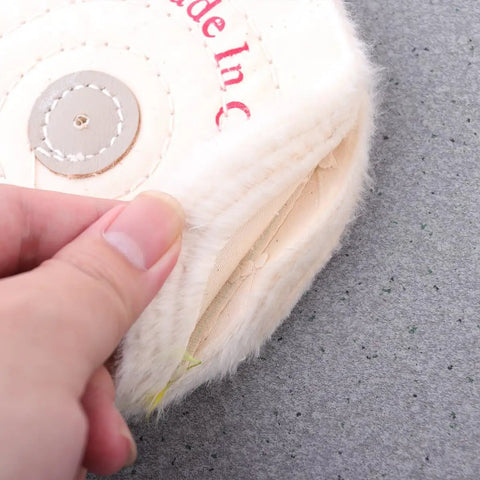 Close-up of Low Noise 6 Inch Cloth Buffing Wheels 2 Pack White Felt Polishing Pads For Grinder with hand holding edge