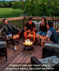 Friends enjoy evening on patio with Firecube 14 Inch Portable Smokeless Propane Fire Pit With Carry Kit And Lava Rocks, 58,000 BTU, Black.