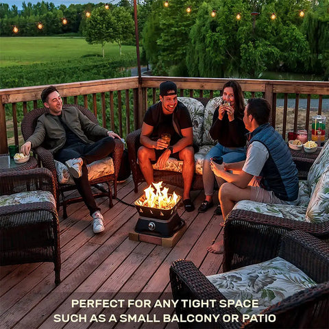 Friends enjoy evening on patio with Firecube 14 Inch Portable Smokeless Propane Fire Pit With Carry Kit And Lava Rocks, 58,000 BTU, Black.